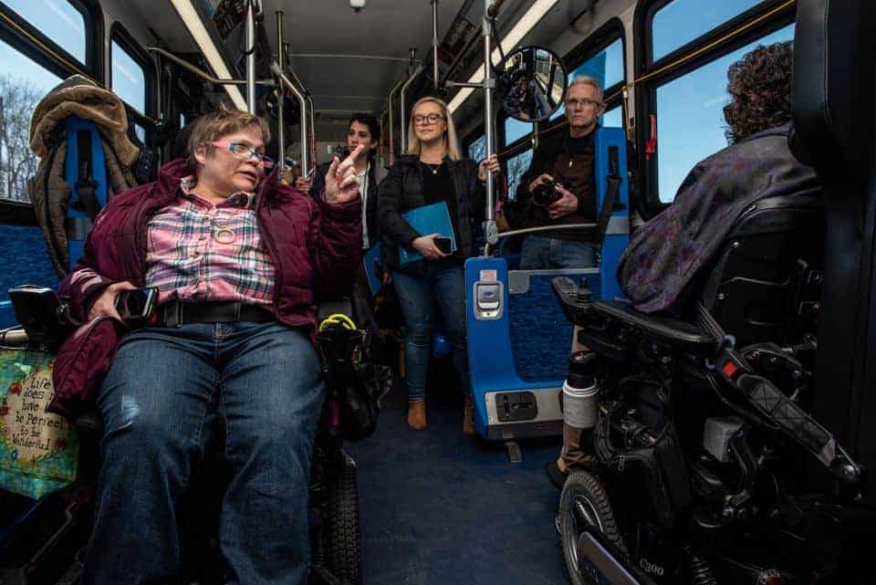 People in wheelchairs on a bus