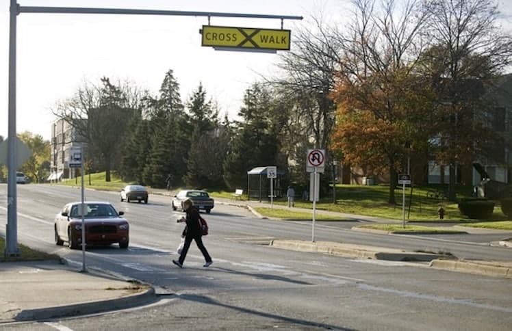 A pedestrian crossing the street in Ann Arbor