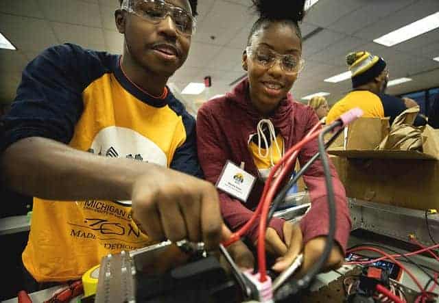 Members of Davis Aerospace High School work on their team's robot